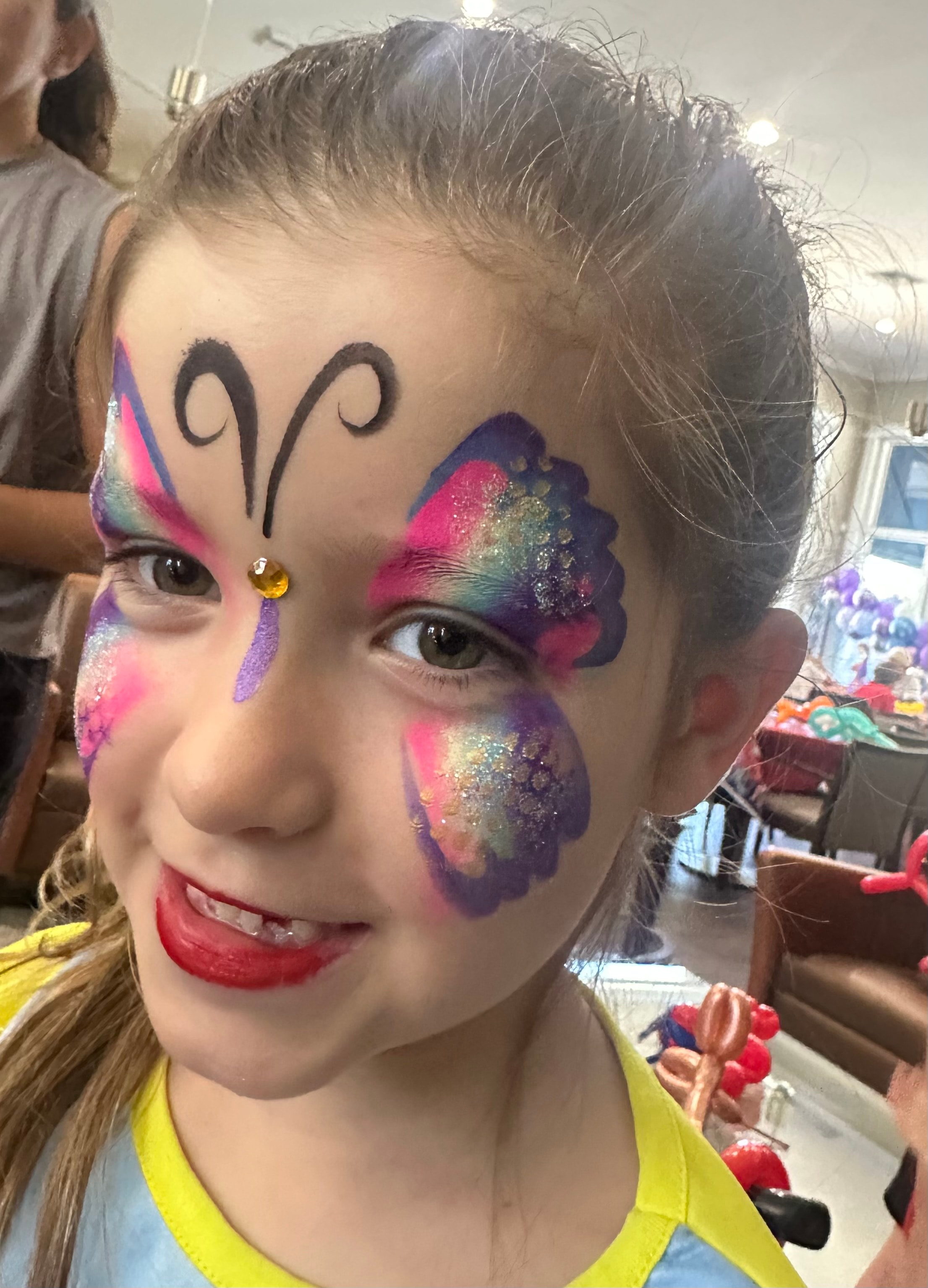 Butterfly glitter face painting by OOOPSY Face Painting Team