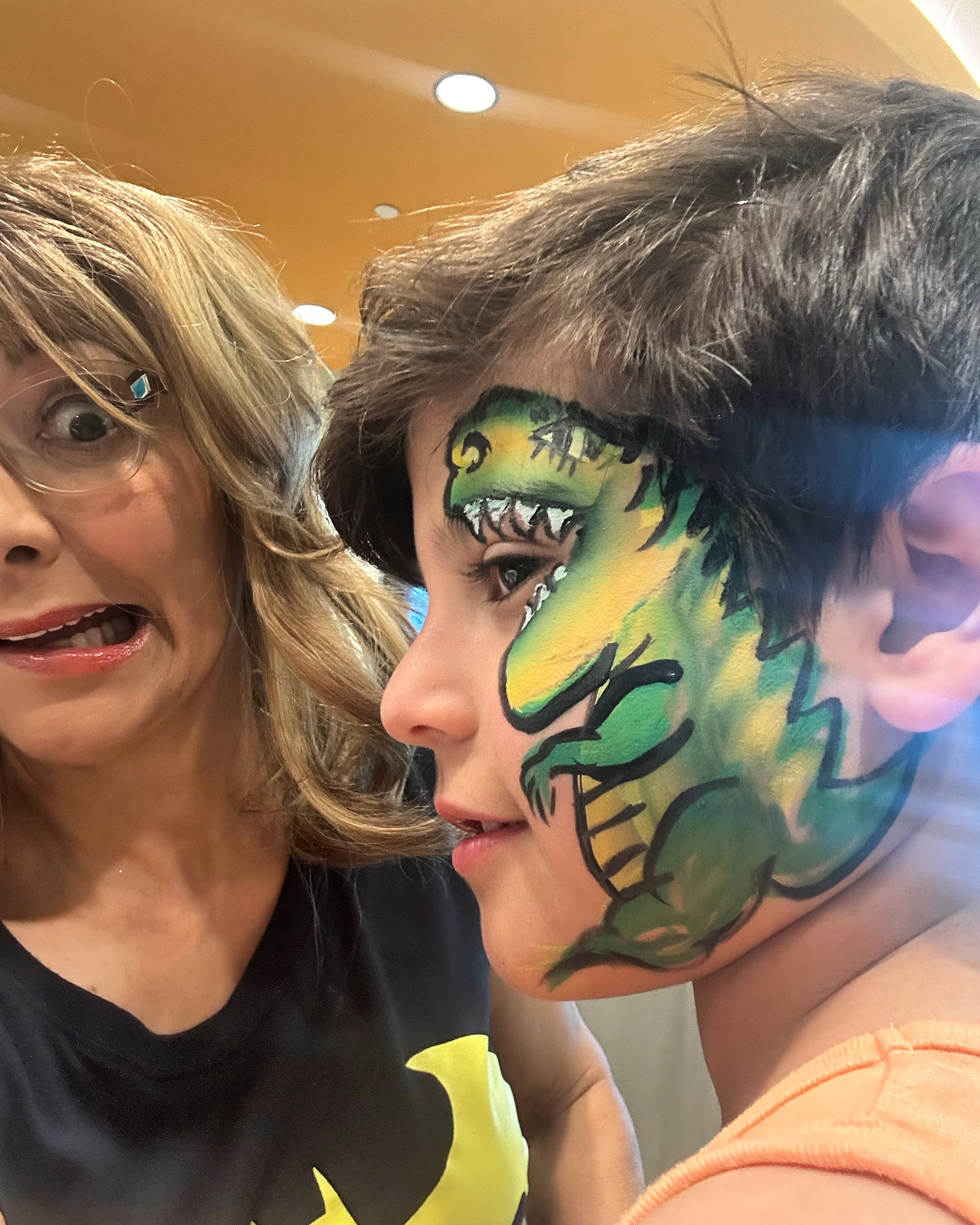 Dinosaur face painting by OOOPSY Face Painting Team